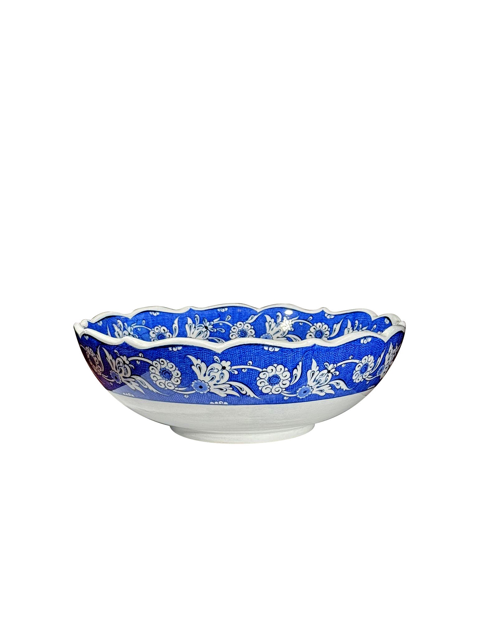 Decorative iznik bowl with blue floral pattern on a white background