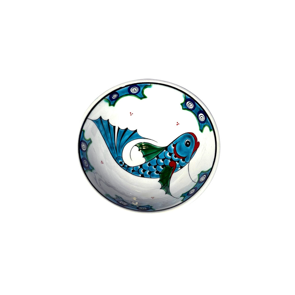 Decorative iznik bowl with a fish design on a white background