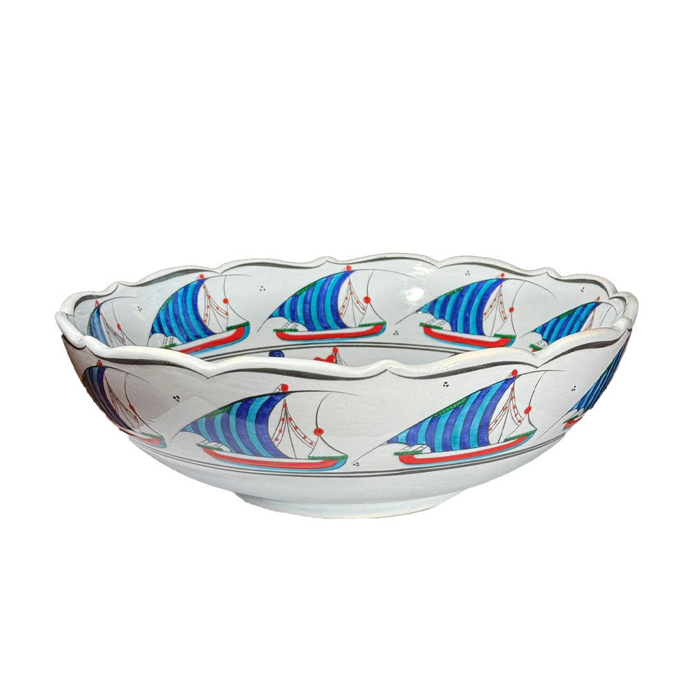 Decorative bowl with sailboat design on a white background