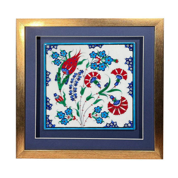 Decorative tile with floral design framed in gold and blue