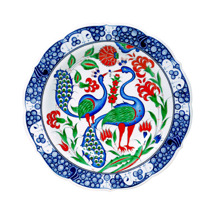 Iznik plate peacock bird motif with roses and lilies, edges wave and rock pattern. 
