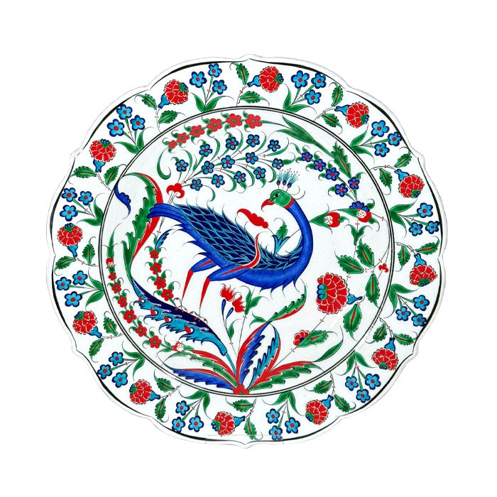 Decorative iznik plate with a peacock and floral design on a white background