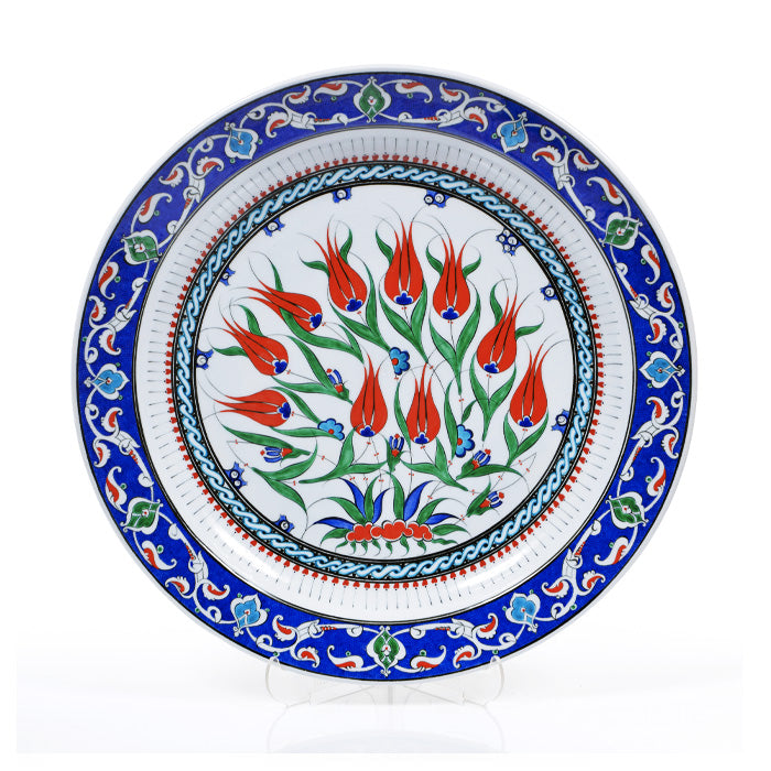 Decorative Iznik plate with floral design and blue border on a white background